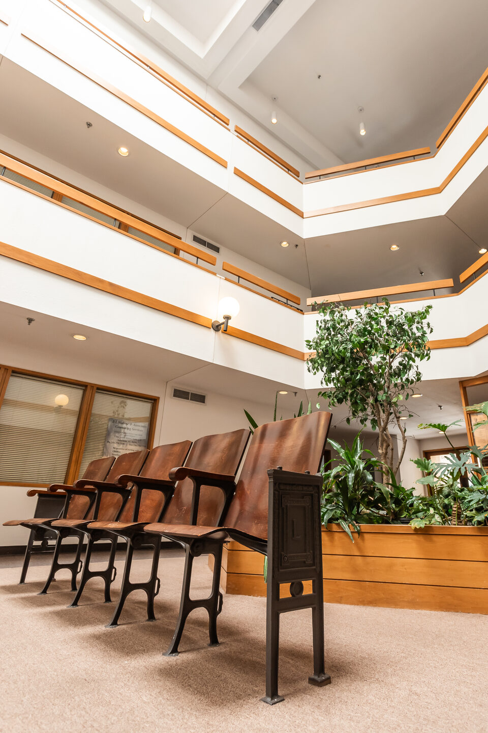 Original wooden theatre seats preserved in the atrium at Lyric Square, Anniston, Alabama